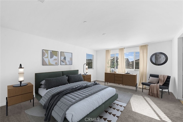 bedroom featuring carpet and baseboards