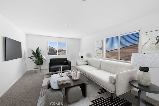 living room featuring carpet and baseboards