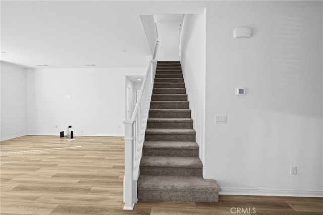 staircase with wood-type flooring