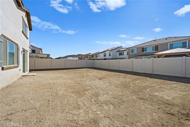 view of yard with a fenced backyard and a residential view