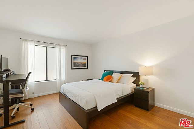 bedroom with hardwood / wood-style flooring