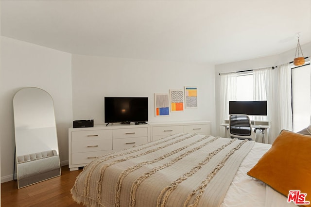 bedroom with dark hardwood / wood-style floors