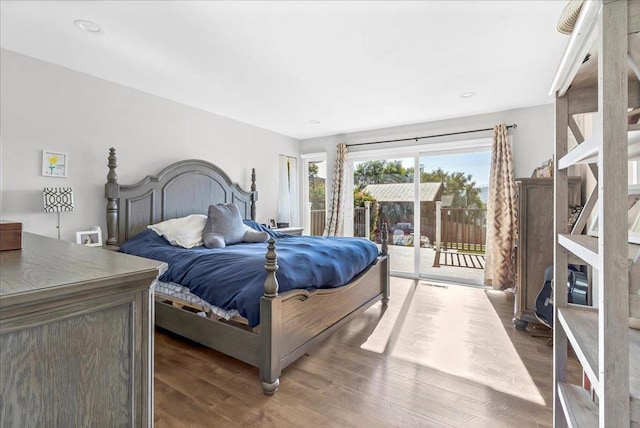 bedroom with dark wood-type flooring and access to outside