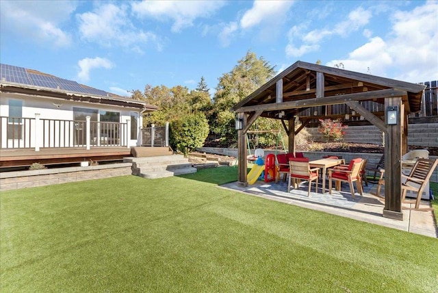 view of yard featuring a gazebo, a wooden deck, and a patio