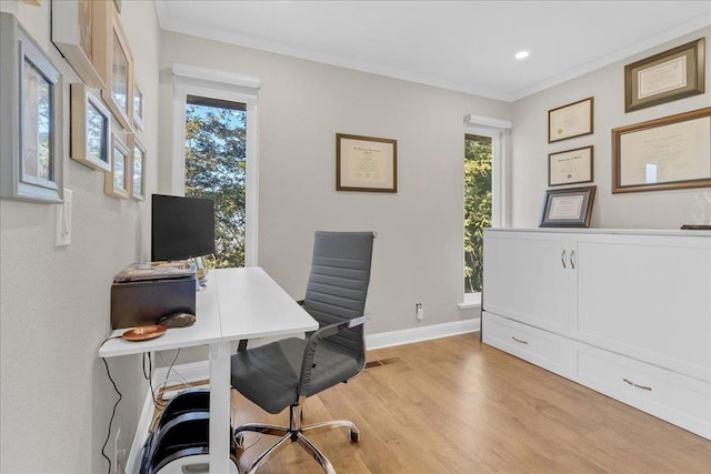 office with ornamental molding and light wood-type flooring