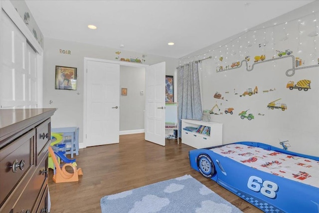 bedroom featuring dark hardwood / wood-style flooring and a closet