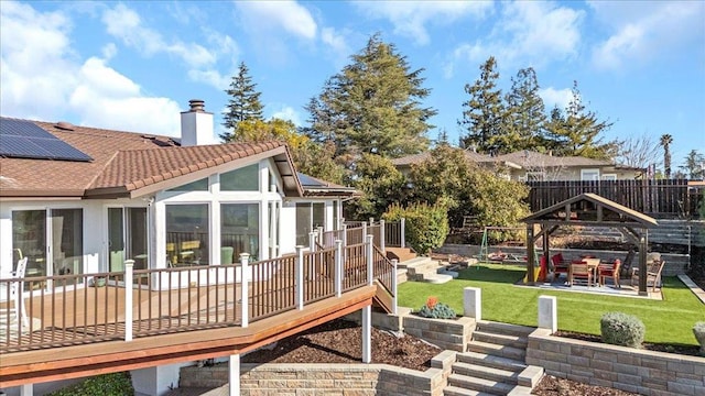 back of house featuring a gazebo, a yard, a deck, and a patio