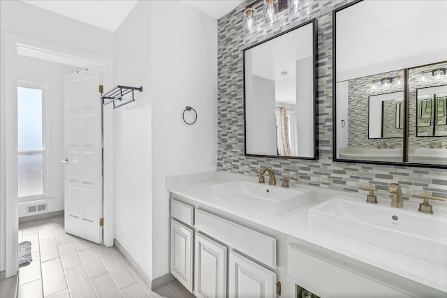 bathroom featuring tasteful backsplash, vanity, and tile patterned flooring