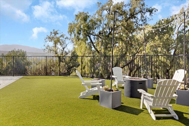 view of yard featuring a mountain view and a fire pit