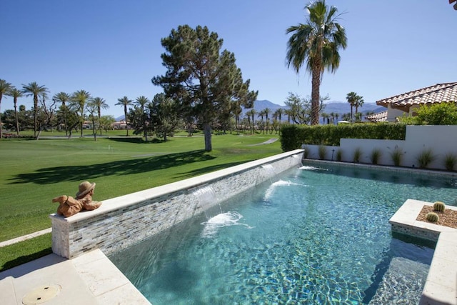 view of pool featuring pool water feature, a lawn, and a mountain view