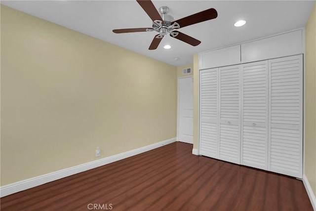 unfurnished bedroom with ceiling fan, a closet, and dark hardwood / wood-style flooring