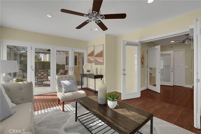 living room with ceiling fan, dark hardwood / wood-style flooring, and french doors