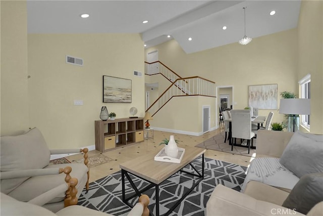 living room with high vaulted ceiling and beamed ceiling