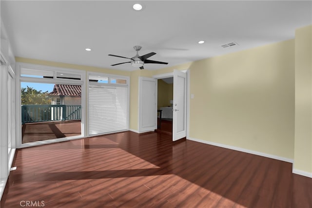 spare room featuring ceiling fan and dark hardwood / wood-style floors