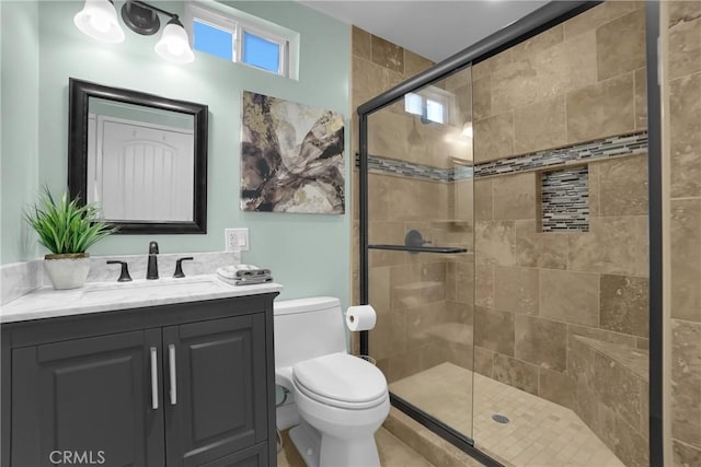 bathroom with toilet, walk in shower, and vanity