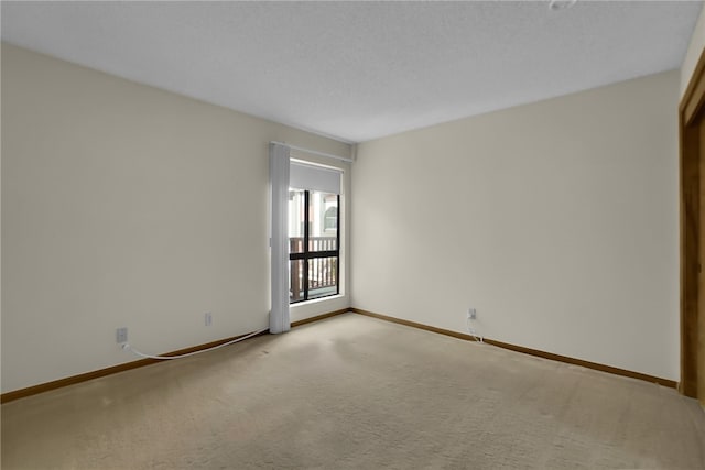 spare room featuring light colored carpet