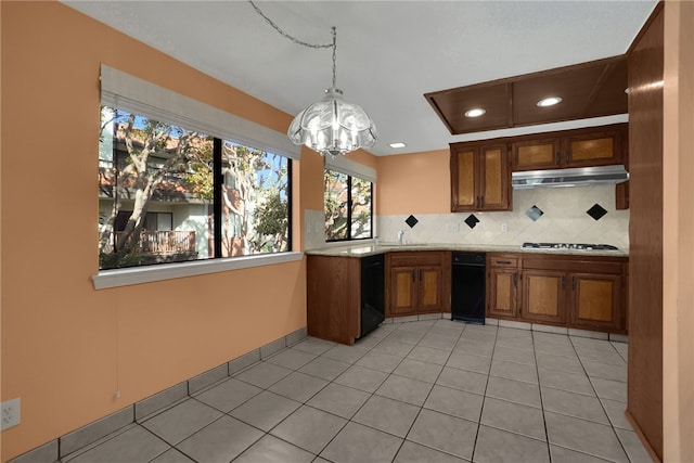 kitchen with dishwasher, decorative backsplash, sink, hanging light fixtures, and light tile patterned floors