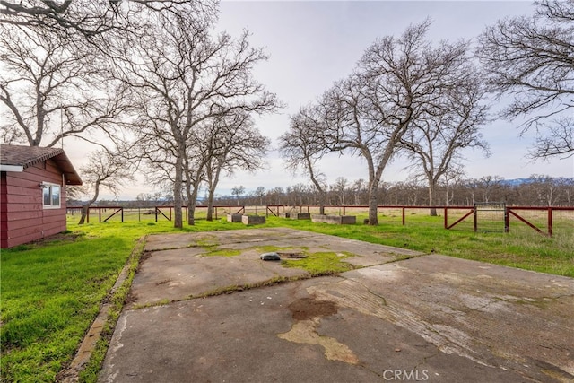 view of yard with a rural view and a patio