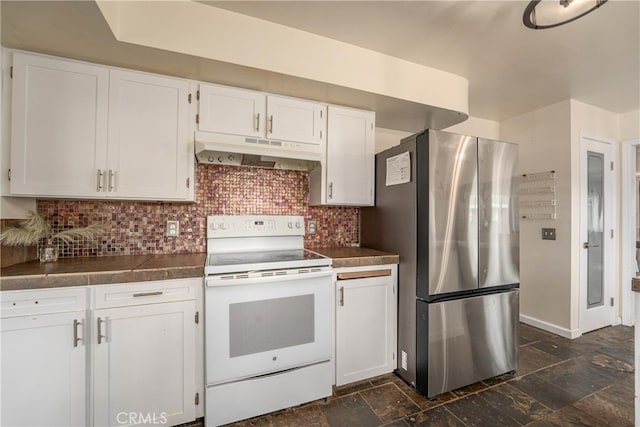 kitchen featuring decorative backsplash, white cabinets, stainless steel fridge, and white electric range oven