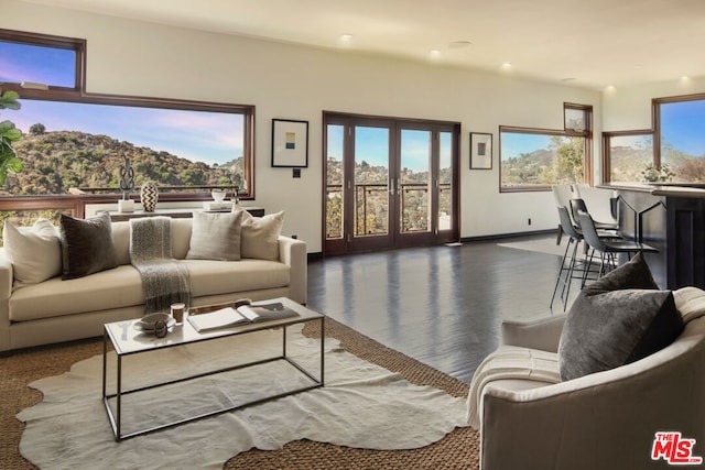 living room featuring a mountain view and french doors