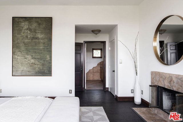 bedroom with dark hardwood / wood-style floors