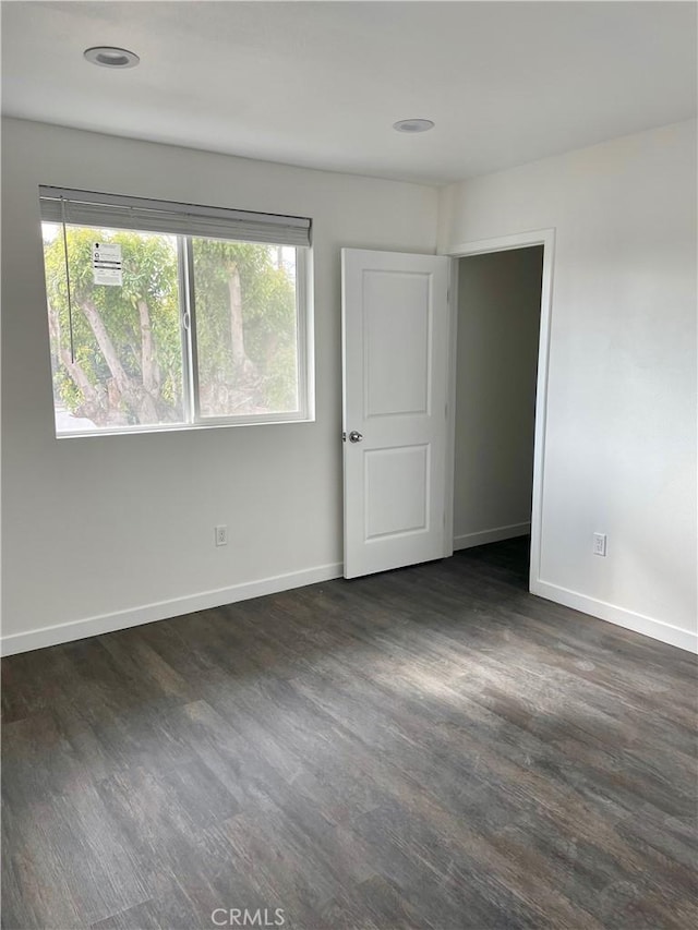 spare room featuring dark hardwood / wood-style floors