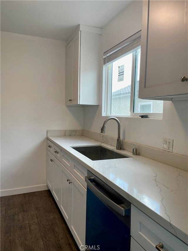 kitchen with dark hardwood / wood-style floors, black dishwasher, sink, white cabinets, and light stone countertops