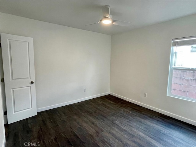 unfurnished room featuring ceiling fan and dark hardwood / wood-style floors