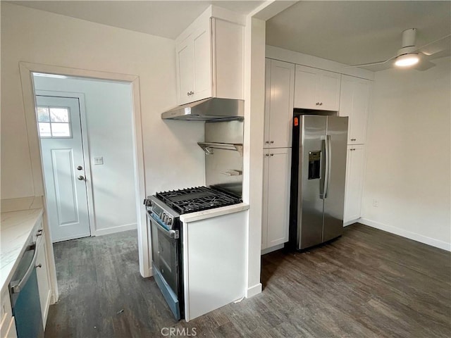 kitchen featuring stainless steel appliances, white cabinetry, light stone countertops, and dark wood-type flooring