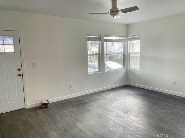 entrance foyer featuring ceiling fan, plenty of natural light, and dark hardwood / wood-style flooring