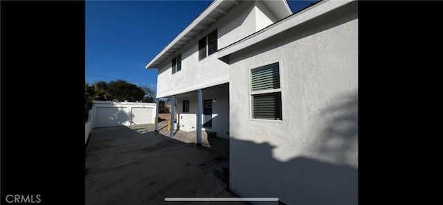 view of side of property featuring a patio area