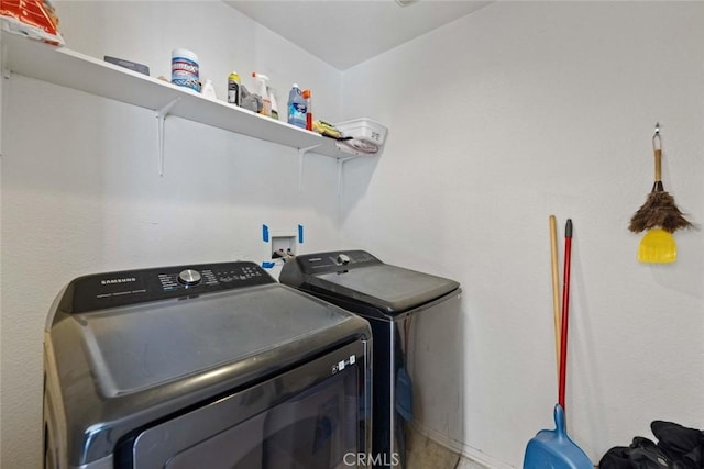 clothes washing area featuring independent washer and dryer