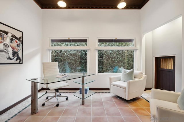 tiled home office with a high ceiling