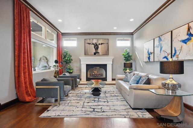 living room with hardwood / wood-style flooring, a wealth of natural light, and crown molding