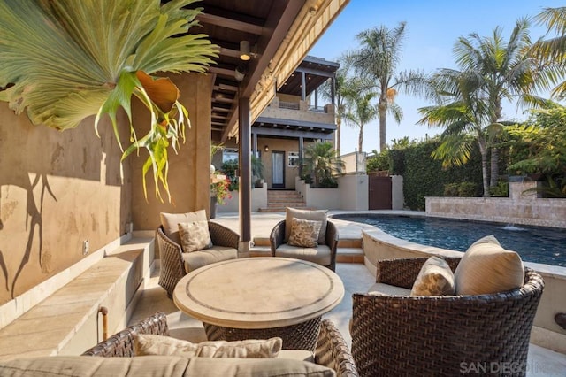 view of pool featuring pool water feature and an outdoor hangout area