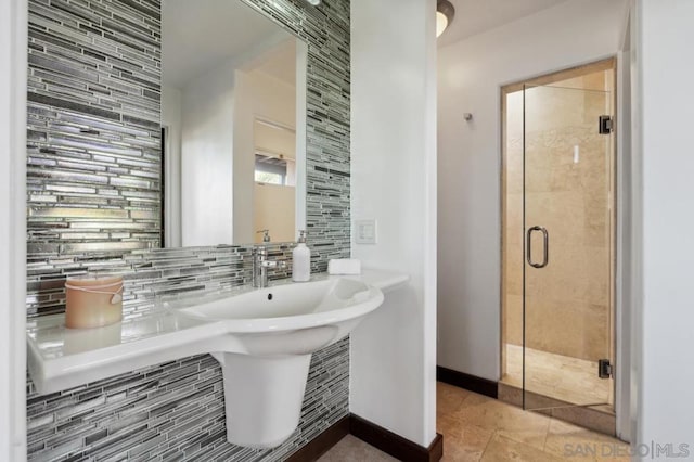 bathroom with an enclosed shower and tasteful backsplash