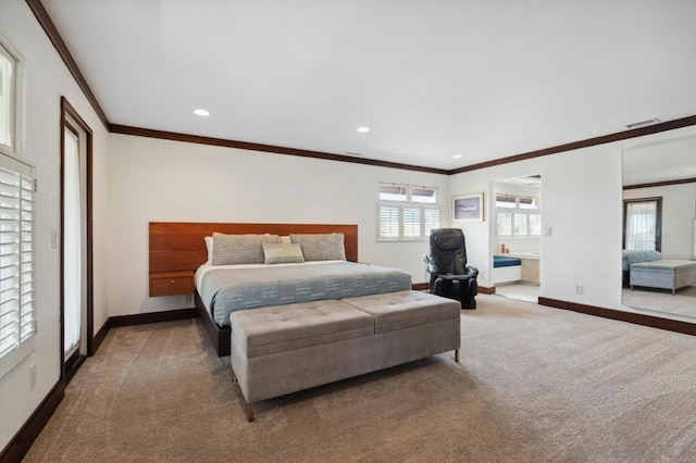 carpeted bedroom with connected bathroom and ornamental molding