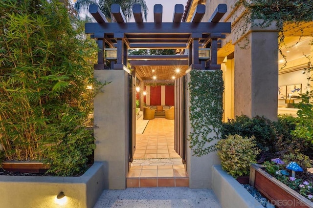 entrance to property with a patio and a pergola