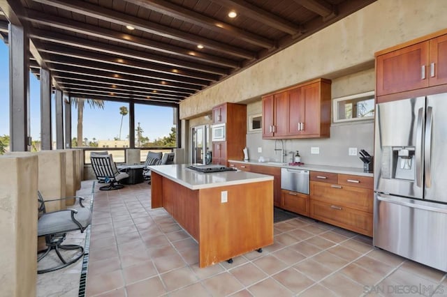 kitchen with a center island, wood ceiling, stainless steel refrigerator with ice dispenser, beam ceiling, and built in microwave