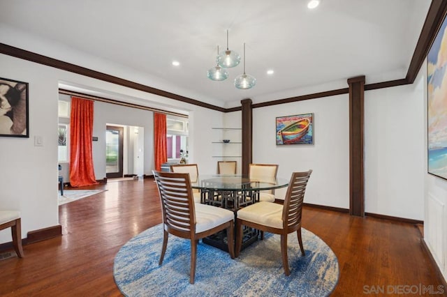 dining room with dark hardwood / wood-style floors and ornamental molding