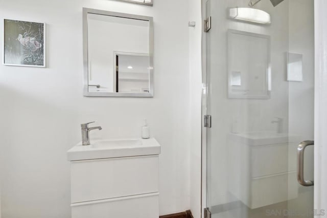 bathroom with an enclosed shower and vanity