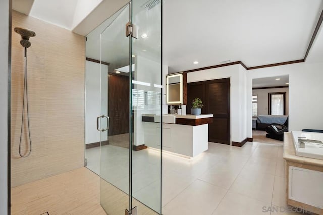 interior space featuring vanity, tile patterned flooring, crown molding, and walk in shower