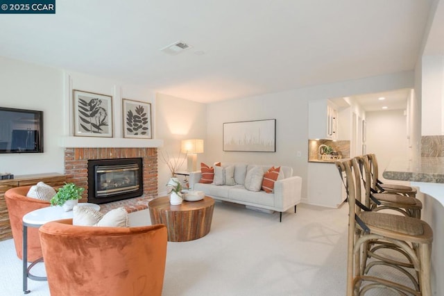 living room with light carpet and a fireplace