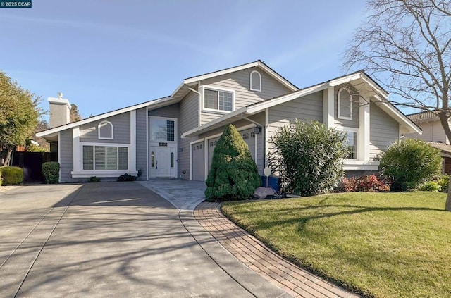 view of front property featuring a garage and a front lawn