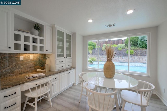 dining space featuring light hardwood / wood-style flooring and built in desk