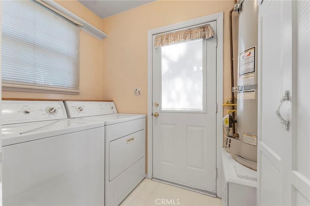 clothes washing area featuring separate washer and dryer and a healthy amount of sunlight