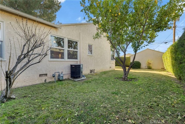 view of home's exterior featuring central AC unit and a lawn