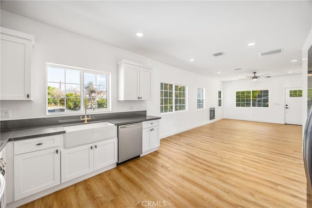 kitchen with sink, light hardwood / wood-style flooring, ceiling fan, white cabinets, and stainless steel dishwasher