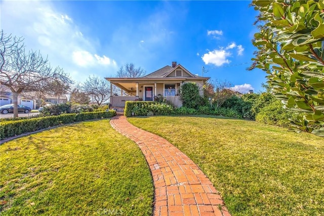 view of front of home featuring a front yard and covered porch