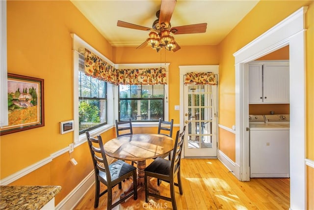 dining space featuring ceiling fan, washing machine and clothes dryer, and light hardwood / wood-style floors